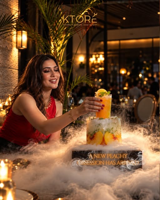 A peach mocktail served over a smoking ice sculpture